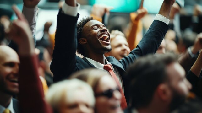 Happy diverse crowd celebrating success at a corporate event with raised hands and cheerful expressions indoors