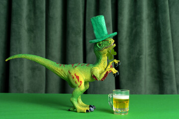 Funny dinosaur in green hat with beer  celebrating St. Patrick's day.