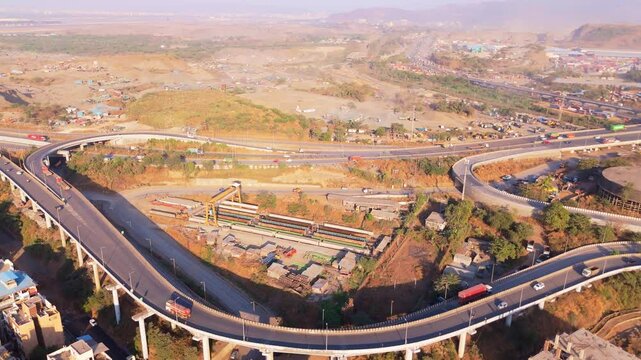 Drone shot strategic roadway connecting city and industry