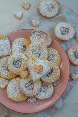 Linzer cookies with heart with raspberry jam and powdered sugar 