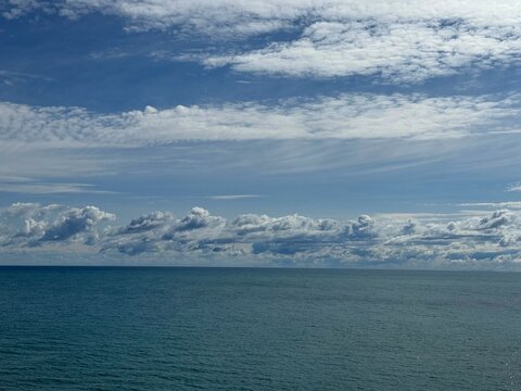 Scenic clouds over calm blue ocean.