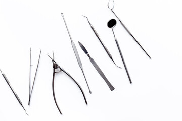 Obraz premium Dental steel instruments on white background, top view. Dentist desk