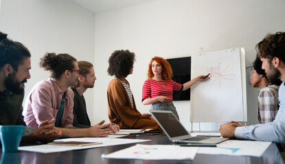 Smiling diverse colleagues gather in boardroom brainstorm discuss financial statistics together