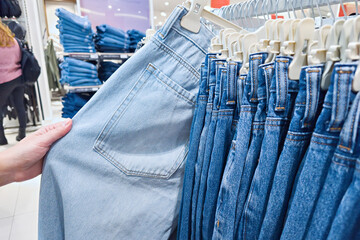 Jeans and woman customer in clothing store