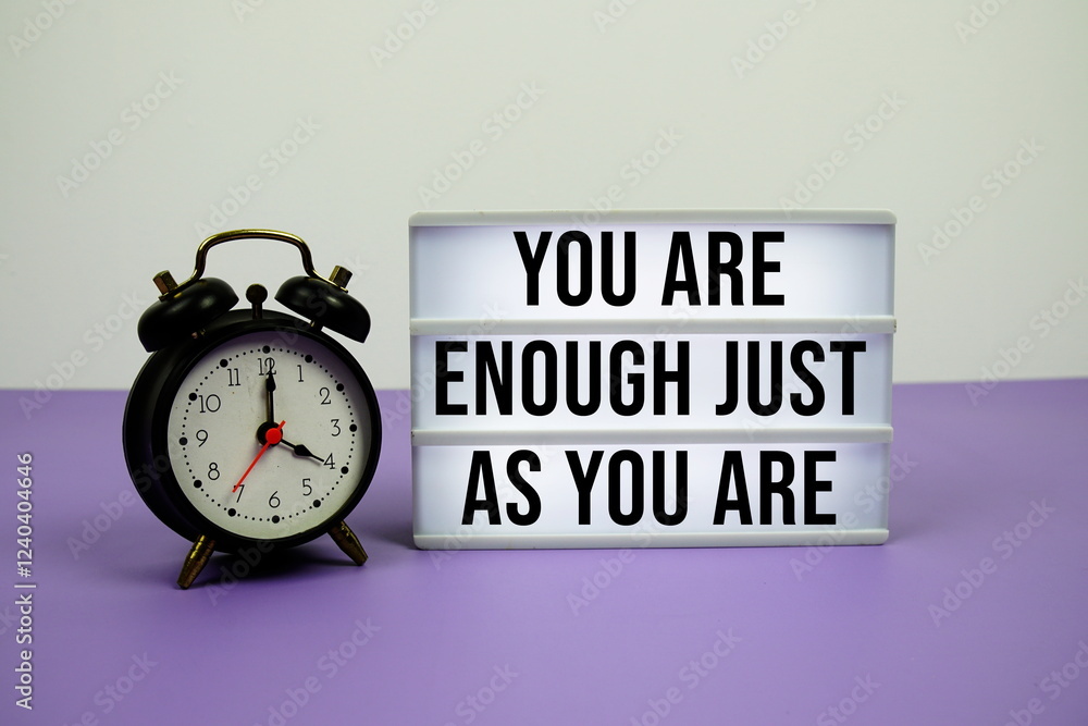 Poster you are enough just as you are text on light box with alarm clock on purple background