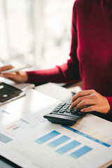 Accountant working on desk using calculator to calculate financial report in office business accounting finance concept