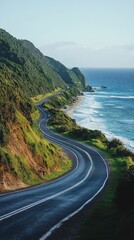 A scenic coastal road winds along a lush green hillside, offering stunning views of the ocean and mountainous terrain.