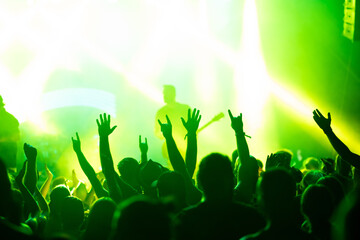 Crowd at concert and colorful stage lights.