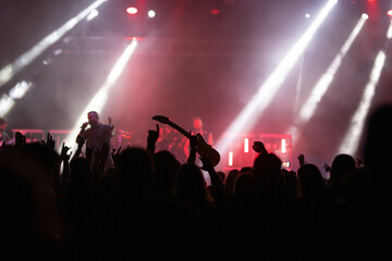 Crowd at concert and blurred stage lights.