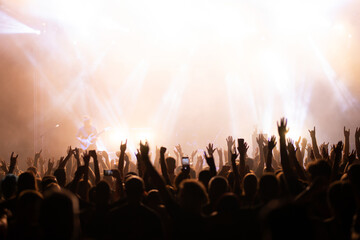 Crowd at concert and blurred stage lights.