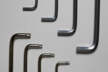 An arrangement of diverse hexagonal keys showing different sizes and shapes on a plain white...