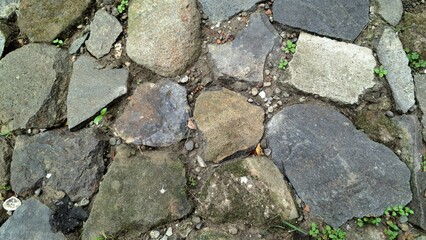 Natural stone background arranged on the ground for wallpaper, backdrop, other natural designs, natural stone texture details, wild natural stone. 