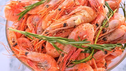 Freshly cooked shrimp infused with garlic flavor delicately seasoned and served with rosemary garnish Garlic enhances taste creating culinary masterpiece Perfect showcasing garlic-infused seafood