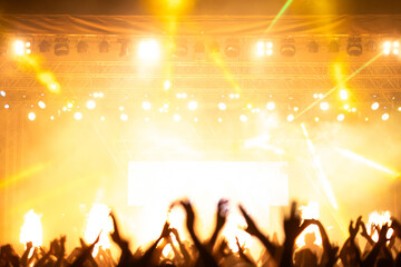 Crowd at concert and colorful stage lights.