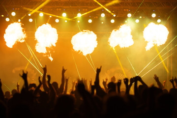 Crowd at concert and colorful stage lights.