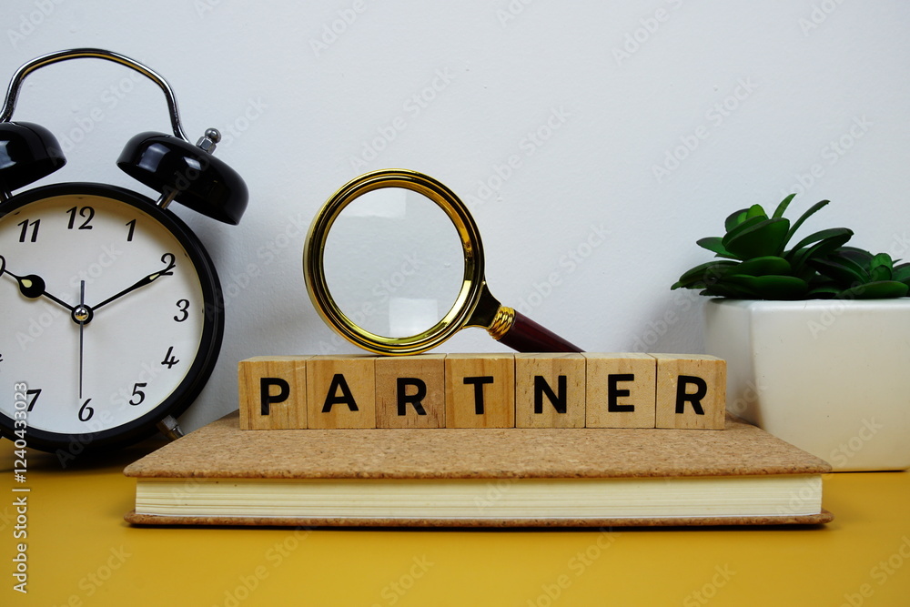 Poster magnifying glass and alarm clock with wooden blocks alphabet letters partner text message on yellow 