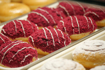 Delicious red velvet donuts displayed fresh at pastry shop