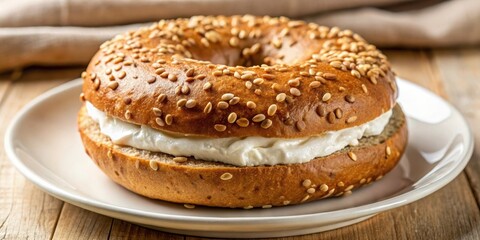 A delicious sesame seed bagel topped with a generous layer of creamy spread, presented on a simple white plate, ready to be enjoyed