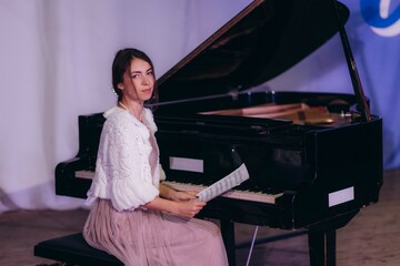 Elegant Woman Preparing to Perform Music on Grand Piano in Classical Atmosphere