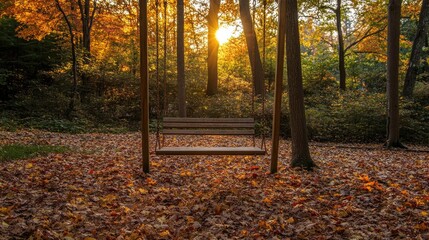 Obraz premium Wooden swing surrounded by vibrant autumn leaves, with golden sunlight filtering through the trees in the background