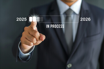 Progress Bar 2025-2026, A businessman in a sharp suit interacts with a futuristic progress bar interface, symbolizing the transition and planning from 2025 to 2026.