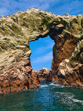 Natural rock arch and seabirds at Ballestas Islands, Paracas, Peru