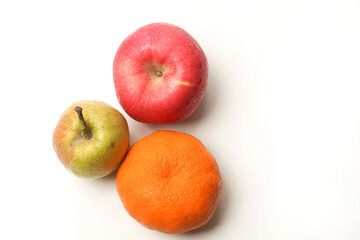 An apple, pear, and orange isolated on white background, top view