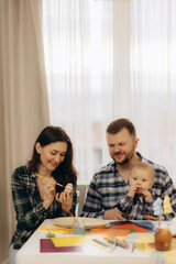 Family Enjoying Artistic Activities and Togetherness at Home by Painting Crafts