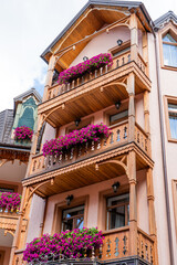 Petunia flowers on the balcony of a wooden house.