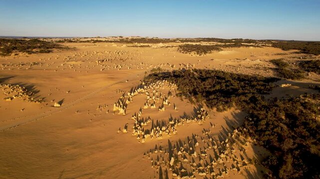 Aerial view of the unique rock formations and vast sandy landscape of the Pinnacles Desert, Nambung National Park, Western Australia.