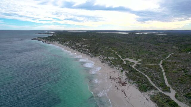 Aerial view of beautiful sandy beach and rugged coastline with tranquil ocean waves, North Head, Jurien Bay Marine Park, Western Australia.