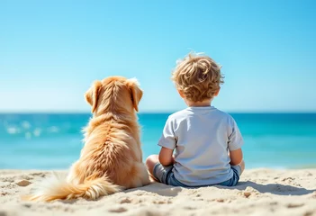 Wall murals The back of a little child and a dog sitting on a white beach and looking at seascape view on blue sky