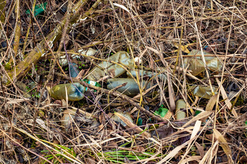 Various kinds of trash waste objects a lot floating in the pond mixed with aquatic plants