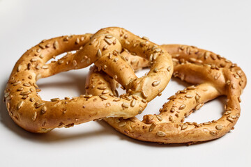 two bagels with sunflower seeds on a white table