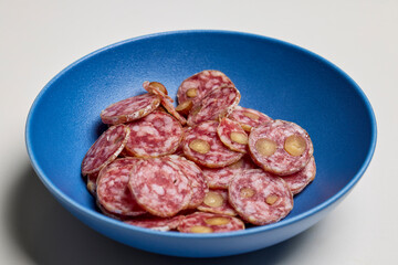 slices of salami with walnuts on a plate