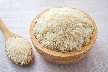 Uncooked white rice in a wooden bowl  ,thai jasmice rice, thai fragrant rice