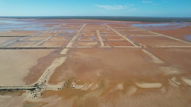 Aerial view of the vast desert landscape with a mining farm and geometric patterns, Lake MacLeod, Gascoyne Region, Australia.