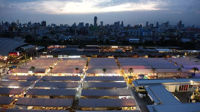 BANGKOK, THAILAND - AUGUST 2024 : View of shops and food stalls at &ldquo;The One Ratchada night market&rdquo; in sunset.