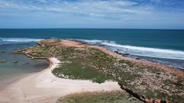 Aerial view of beautiful rugged coastline with tranquil waves and pristine beach, Quobba blowholes, Point Quobba, Gascoyne Region, Australia.