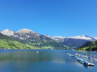 Magic photo of a lake reflecting the mountains during a hike in the Swiss Alps