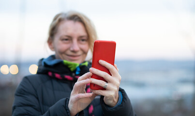 Fototapeta premium woman using her phone outdoors