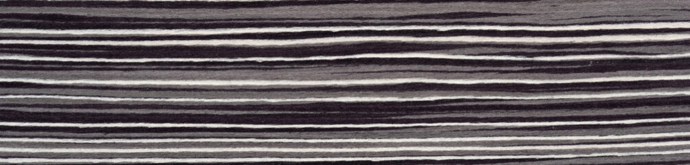 Monochromatic elegance flows in wavy patterns across the surface of this striking Macassar ebony veneer