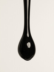Black Liquid Drop Against White Background