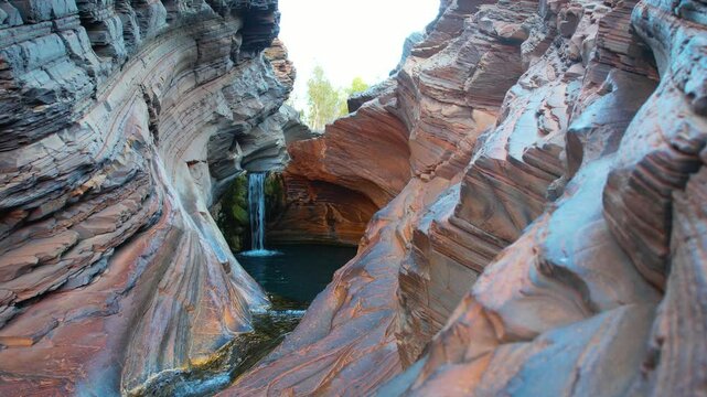 Aerial view of hamersley gorge spa pool with beautiful rock formations and tranquil water, karijini national park, pilbara region, australia.