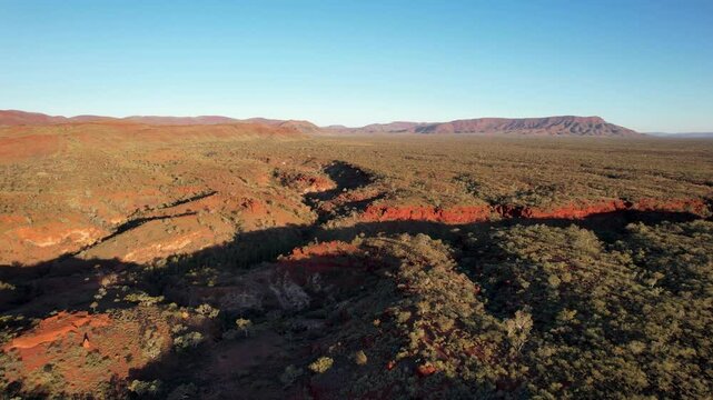 Aerial view of Hamersley Gorge with rugged rock formations and arid vegetation, Tom Price, Australia.