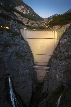 Aerial view of the impressive Diga del Vajont dam surrounded by majestic mountains and a tranquil valley, Erto e Casso, Italy.