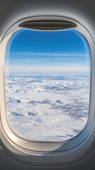 Looking out from an airplane window, a bright blue sky meets a sea of fluffy white clouds on a sunny day high in the atmosphere.