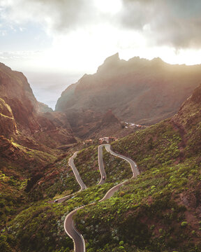 Aerial view of winding road through lush mountain landscape at sunset, Masca, Santa Cruz de Tenerife, Spain.