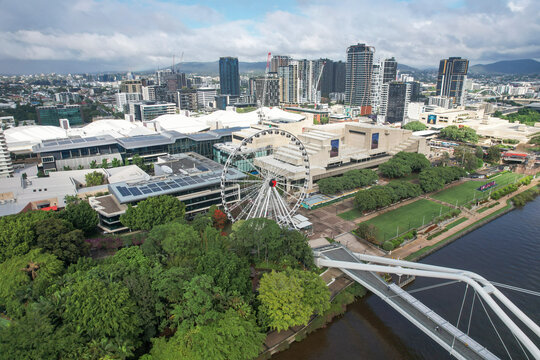 Aerial view of the beautiful cityscape featuring the Wheel of Brisbane, Neville Bonner Bridge, and Brisbane River surrounded by greenery, South Bank, Brisbane, Australia.