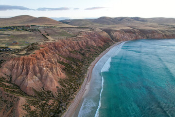 Aerial view of rugged coastline with steep cliffs and beautiful beach, Sellicks Beach, South Australia.